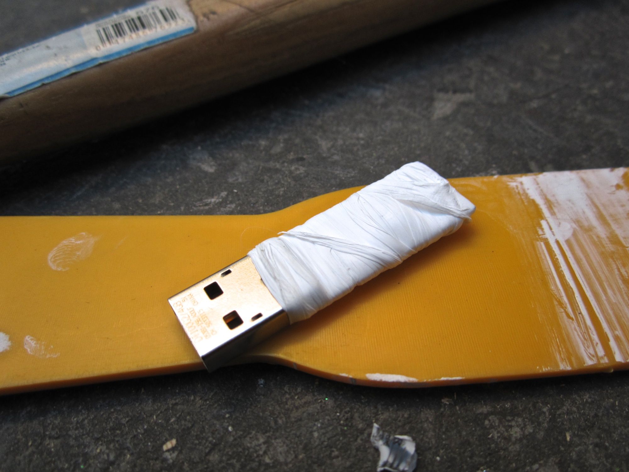A dismantled USB key wrapped in protective tape