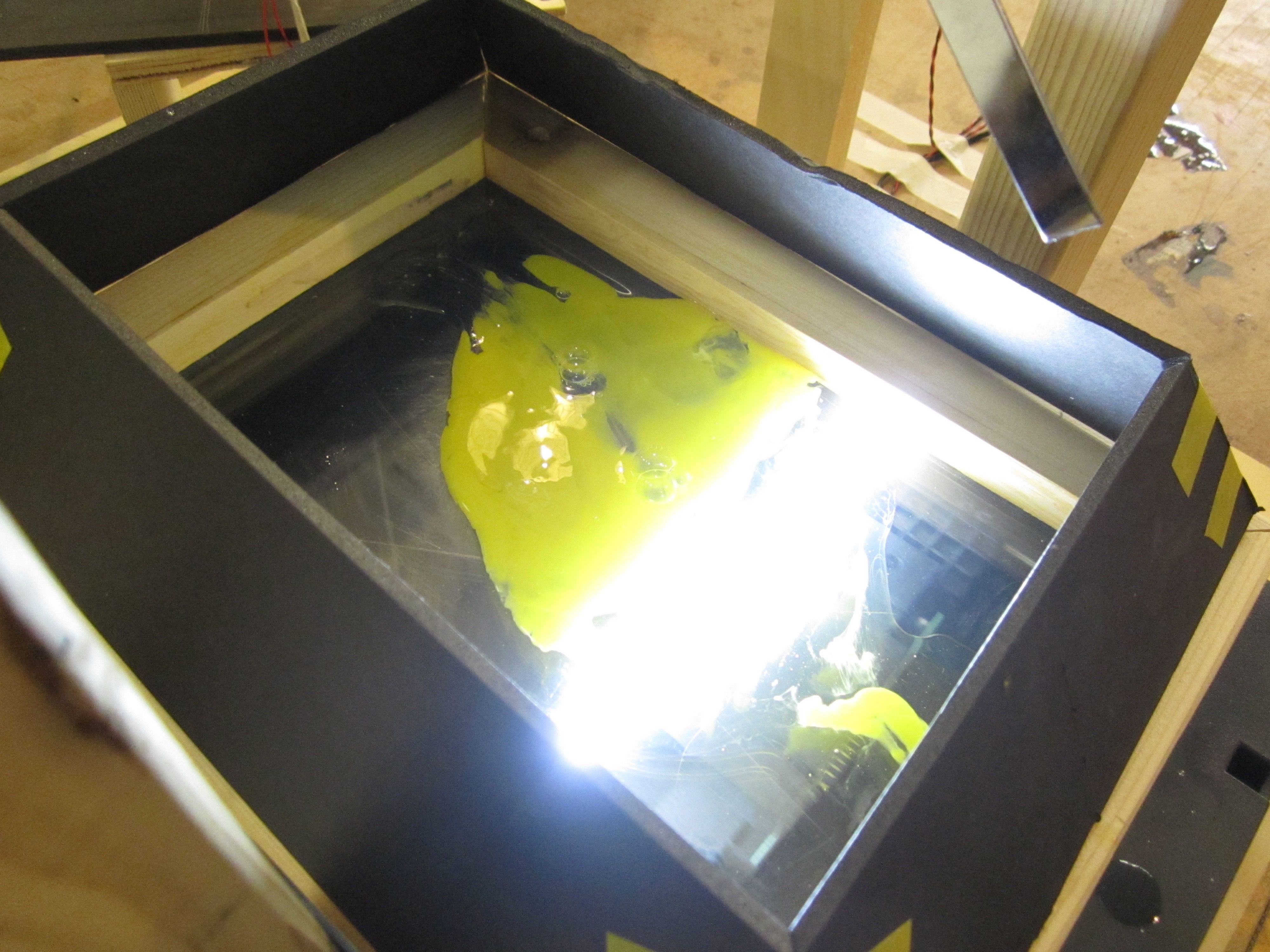 An egg cracked onto a flatbed scanner