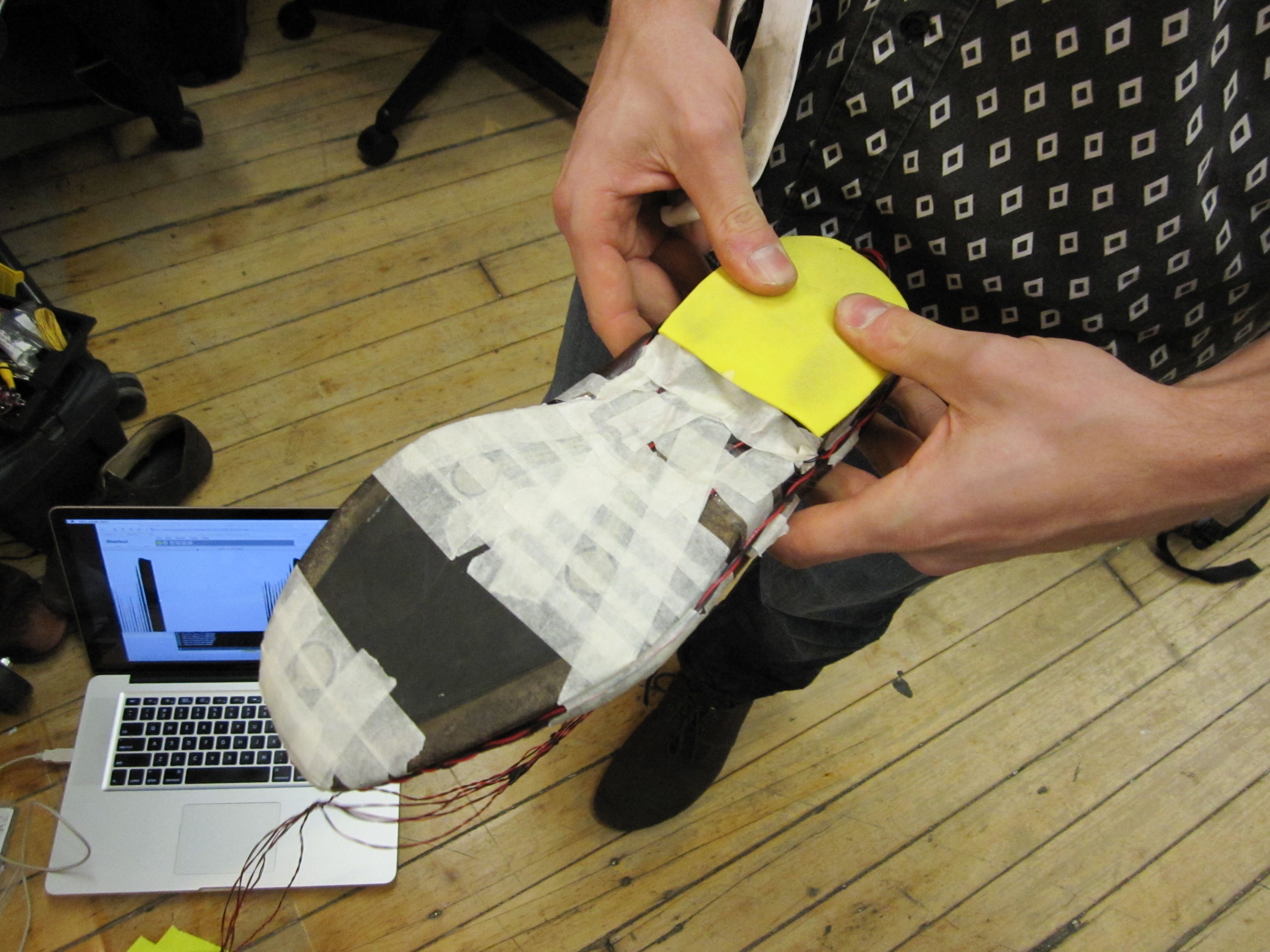 Force sensors taped to the bottom of a shoe