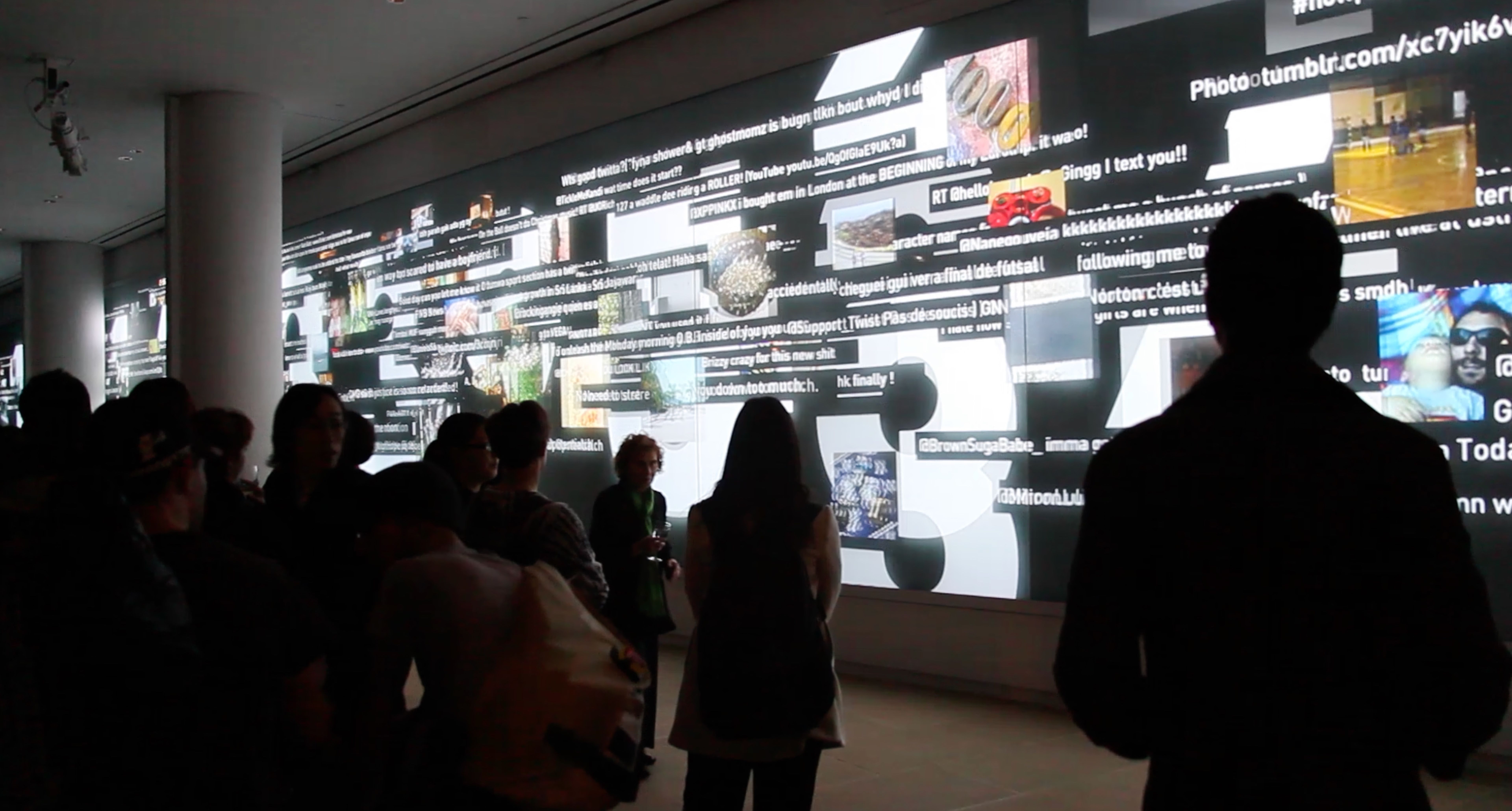 A video wall showing a stream of tweet text