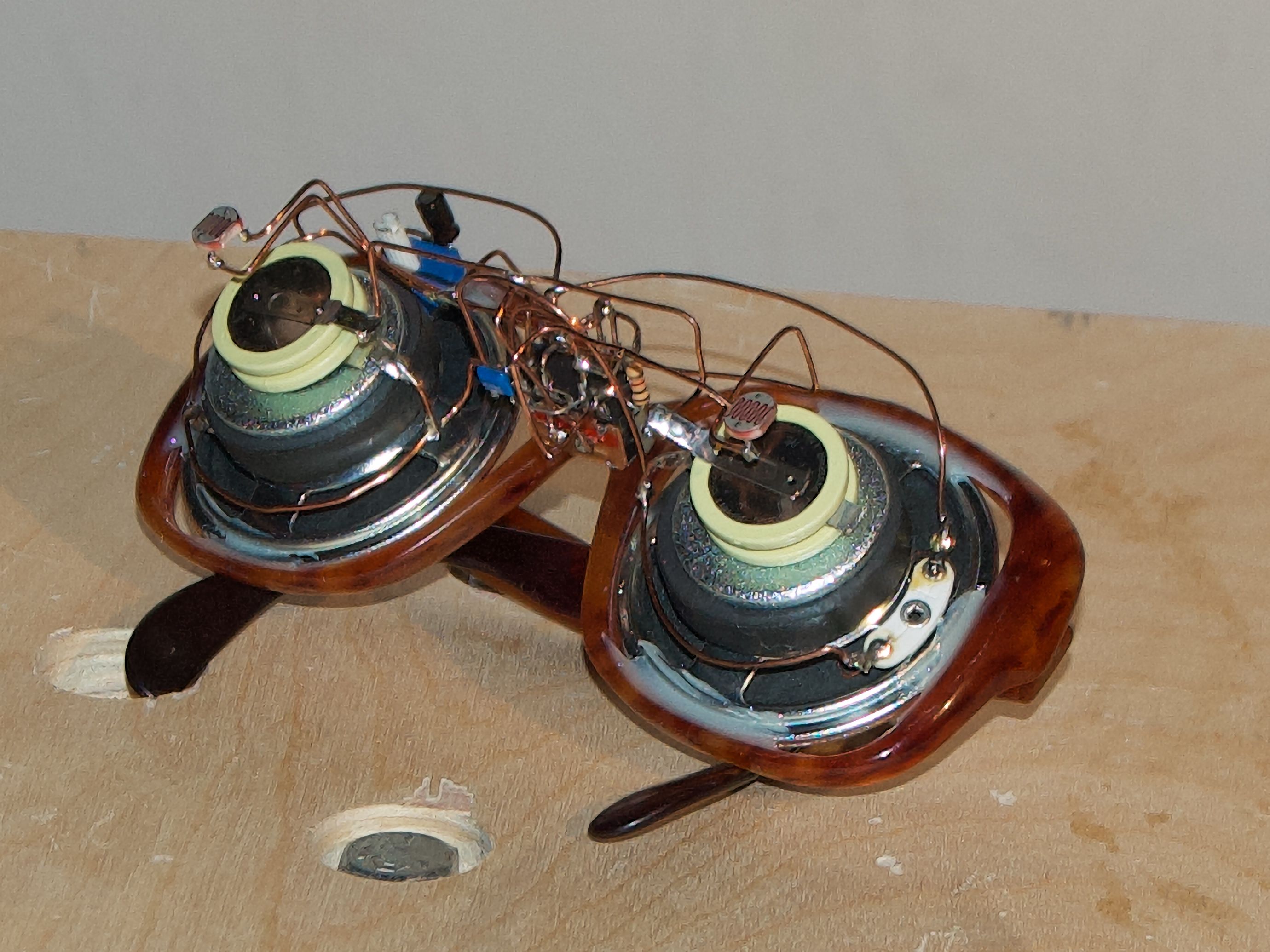 Completed pair of synesthectacles on a wooden plinth