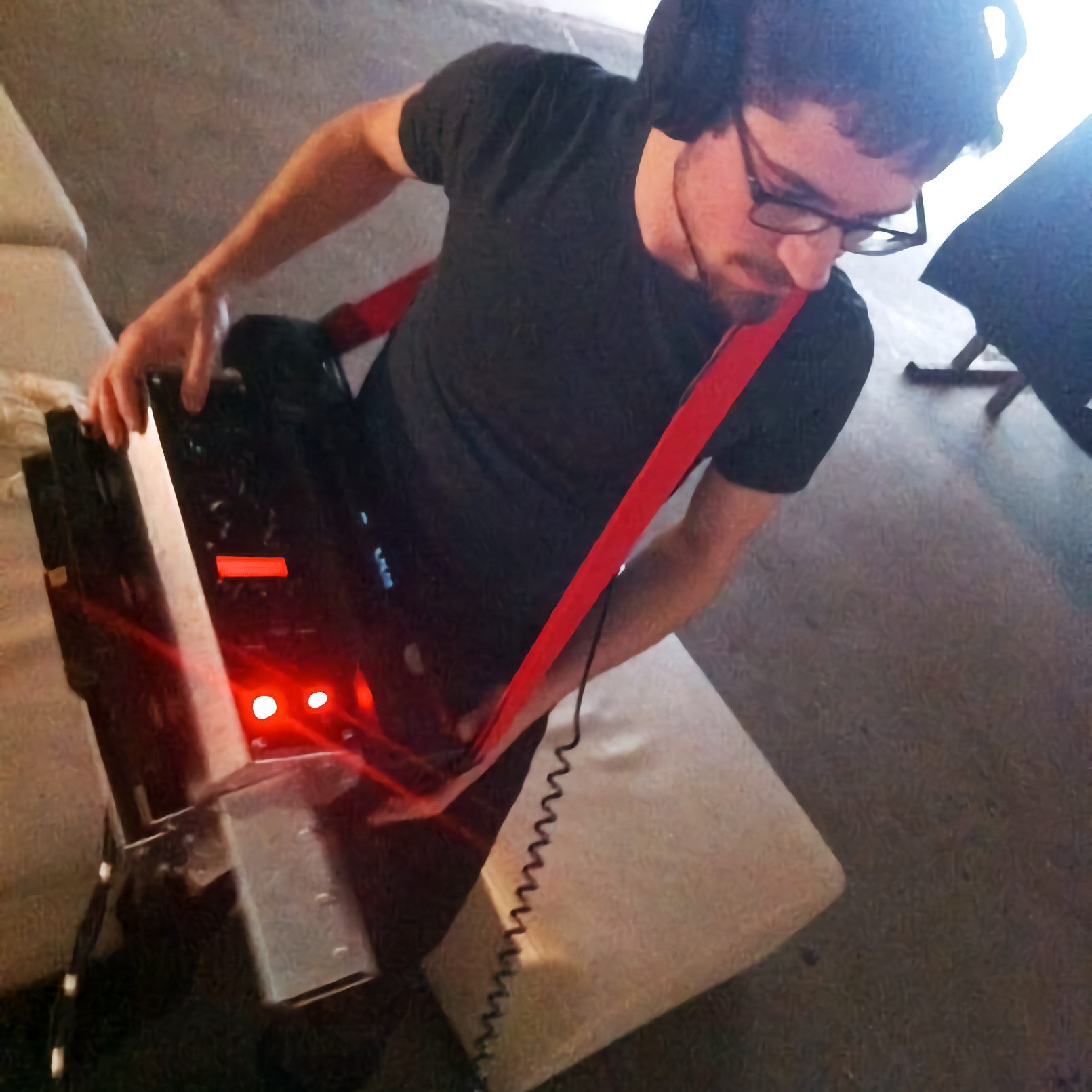 A person with a heavily modified VCR slung over their shoulder.