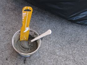 A small container with freshly mixed cement