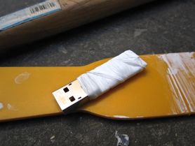 A dismantled USB key wrapped in protective tape