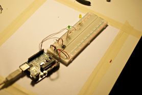 An Arduino attached to a breadboard with multiple LEDs