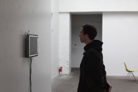 Profile photograph of Joshua Clayton looking at All Thumbs artwork