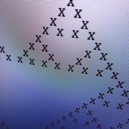 A pixellated pattern of Xs on a computer screen.
