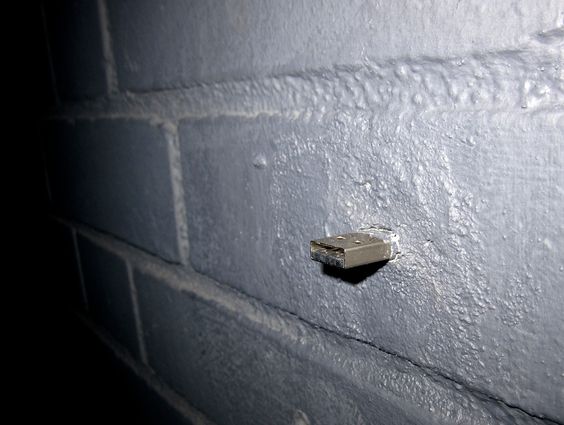 A USB key cemented into a wall at Eyebeam