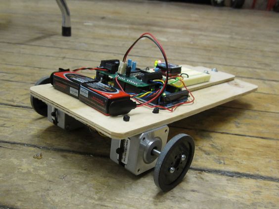 A bare-bones rolling robot on the floor