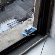 A photo of a webcam in Tupperware placed on a window ledge in a New York apartment.