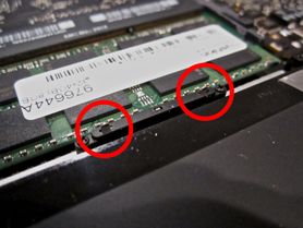Laptop internals with conductive spring pins emphasized