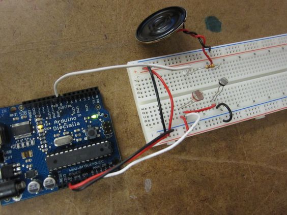 An Arduino connected to a breadboard with photoresistors and a speaker
