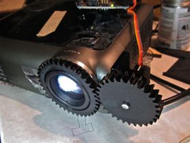 Projector modified with autofocus servo and gearing